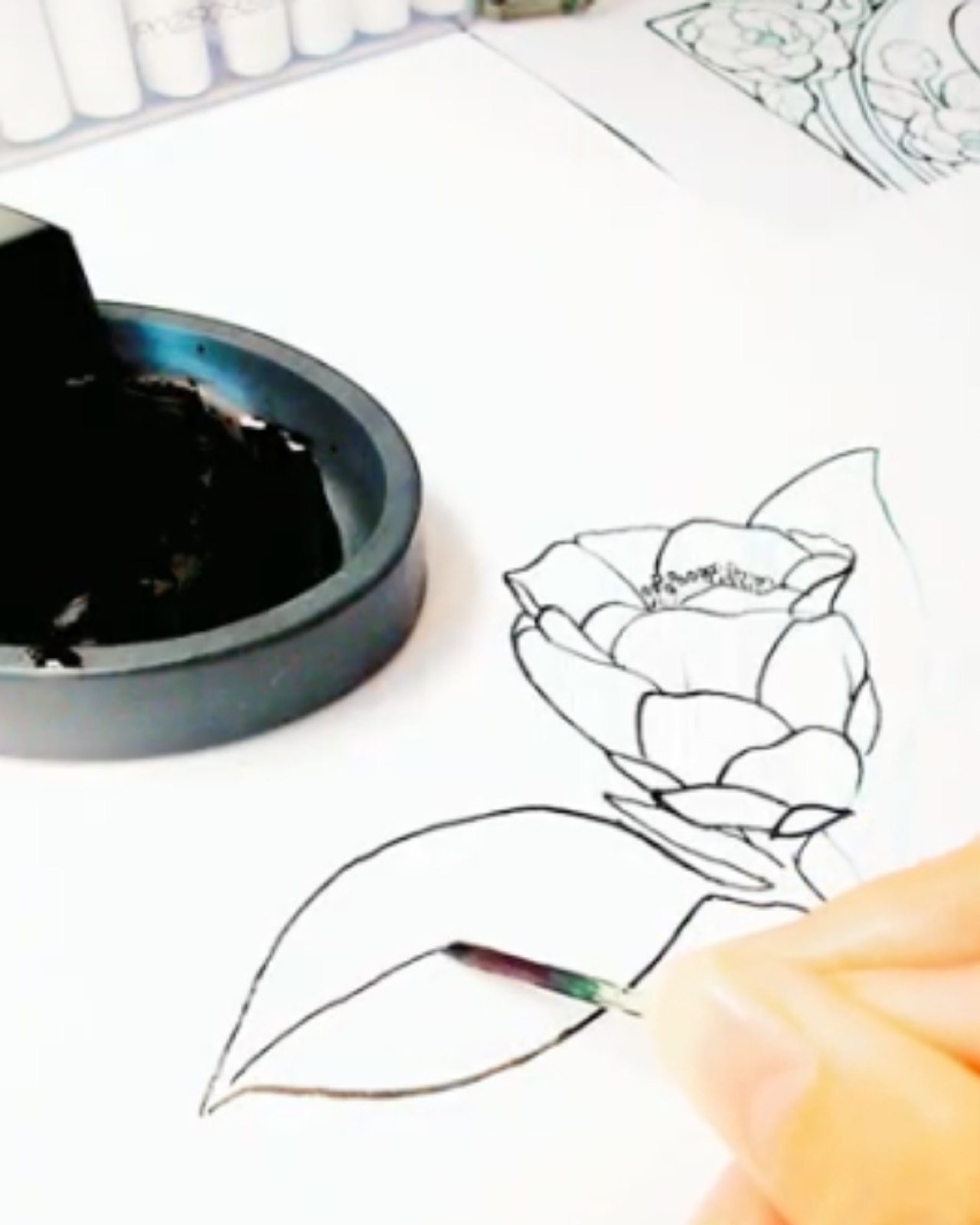 Drawing a camellia by hand with a wooden toothpick dipped in Sumi ink